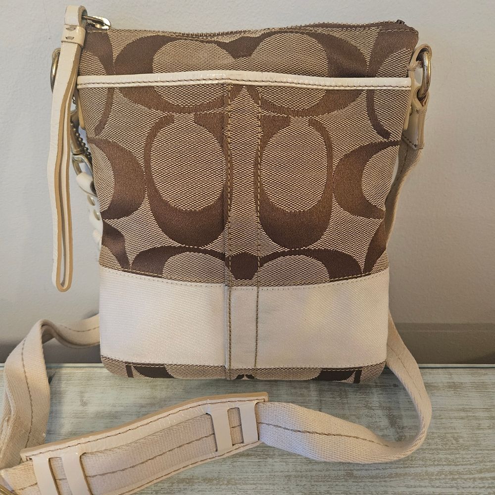 Coach Signature Canvas and Leather Crossbody Bag in beige and white. 
